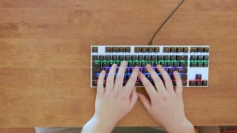 Close up of hands typing on keyboard. Brown background. Negative space. Stock Footage 134154175
