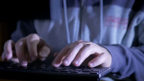 Close-up of hands typing on the keyboard in the dark Stock Footage 72541998