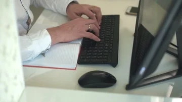 Close-up of hands typing on a keyboard in an home office Stock Footage 85910248