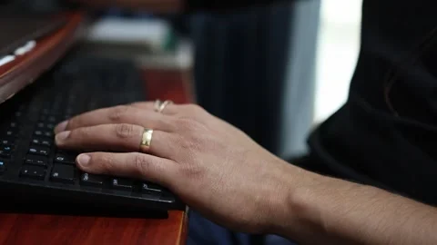 Close-Up of Hands Typing on Keyboard in Office Setting Stock Footage 337273238