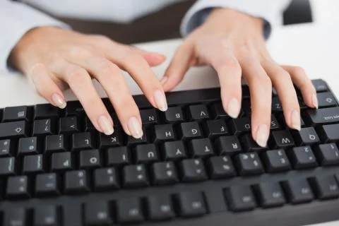 Close up of hands typing on a keyboard Stock Photos