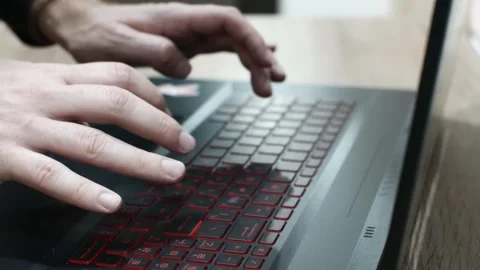 Close-up of hands typing on a keyboard, a programmer writing software games  Stock Footage 300590349