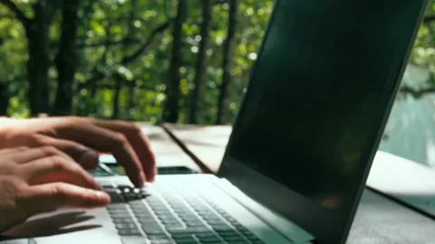 Close-up of hands typing on the keyboard at sunset 스톡 동영상 148987629