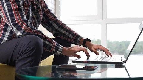 Close-up of hands typing on keyboard. Young man freelancer student sitting on Stock Footage 120936350