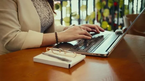 Close-up of hands typing on laptop beside notebook Stock Footage 323899328