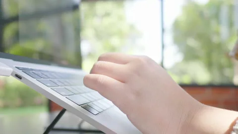 Close up hands typing on laptop at cafe, working at cafe, drinking some coffe Stock Footage 221664871