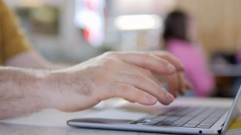 Close-up of hands typing on laptop in casual setting Stock Footage 341181612