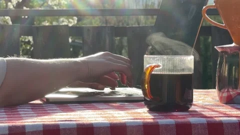 Close up of hands typing on laptop with coffee outdoors 스톡 동영상 333526520