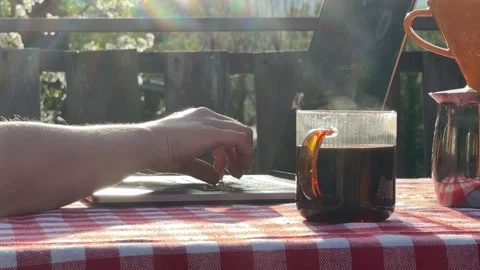 Close up of hands typing on laptop with coffee outdoors Stock Footage 333526588
