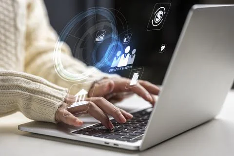 Close-up of hands typing on a laptop with digital overlays representing cor.. Stock Photos