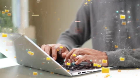 Close-up of hands typing on a laptop with floating digital file icons, represent Video stock 320935508