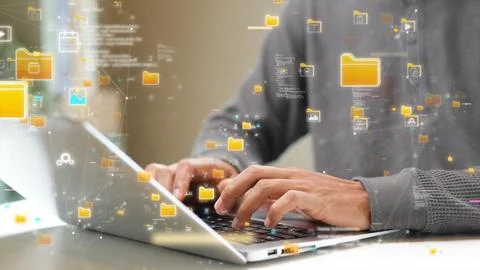 Close-up of hands typing on a laptop with floating digital file icons, repr.. Stock-Fotos
