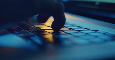 Close up of hands typing on laptop keyboard at night Stock Footage 202613818
