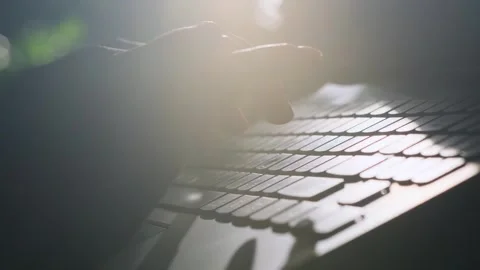Close-up of hands typing on laptop keyboard on dark blurred background. 스톡 동영상 242552187