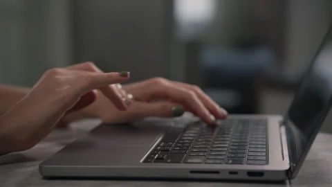 Close-Up of Hands Typing on Laptop Keyboard in Low Light Stock Footage 289542197