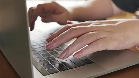 Close-up of hands typing on a laptop keyboard, representing remote work. Stock Footage 314770786