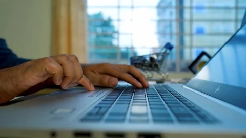 Close-up of hands typing on a laptop keyboard in a bright room Stock Footage 315981366