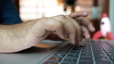 Close-up of hands typing on a laptop keyboard with a blurred background Stock Footage 317736716