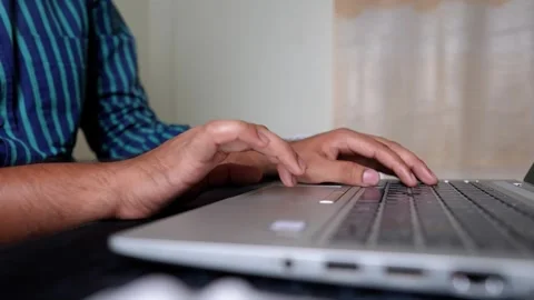 Close-up of hands typing on a laptop keyboard Stock Footage 317737425