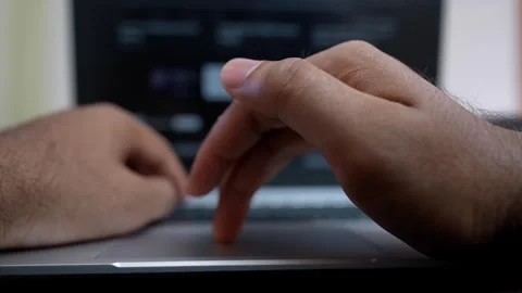 Close-up of hands typing on a laptop keyboard, blurred screen in background Stock Footage 317737494