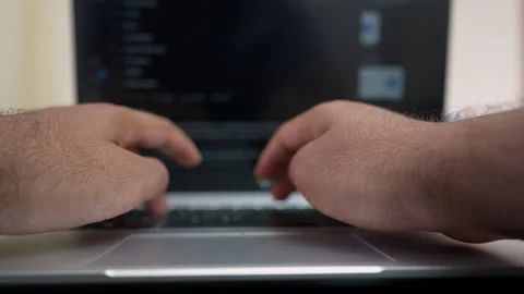 Close-up of hands typing on a laptop keyboard, blurred screen Stock Footage 318056749