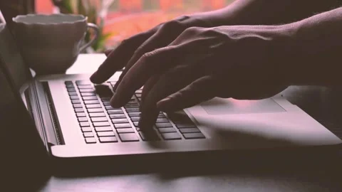 Close-up on Hands Typing on Laptop Keyboard in Dim, Moody Light 2 Stock Footage 320223464