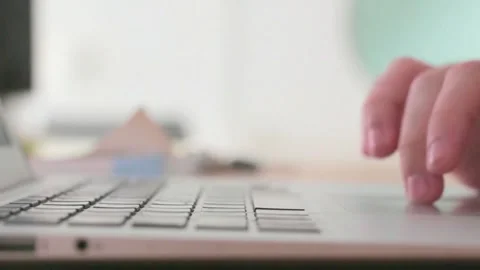 Close-up of Hands Typing on Laptop Keyboard and Using Trackpad Stock Footage 320521294