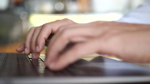 Close-Up Hands Typing on Laptop Keyboard in Modern Office Workspace Stock-Footage 325237338