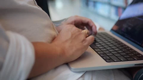 Close-Up of Hands Typing on Laptop Keyboard, Modern Remote... Video stock 334436944