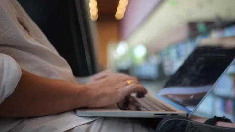 Close-Up of Hands Typing on Laptop Keyboard in Modern Workspace... 動画素材 334436968