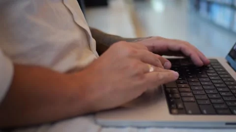 Close-Up of Hands Typing on Laptop Keyboard in Modern Workspace... Vídeo Stock 334437041