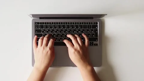 Close-up of hands typing on a laptop keyboard, working on a project Stock Footage 337173307