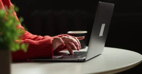 Close-up of hands typing on a laptop keyboard in a cozy indoor setting Stock Footage 339073050