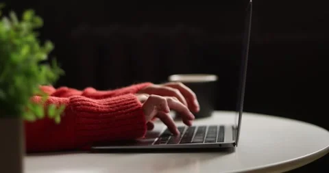 Close-up of hands typing on a laptop keyboard in a cozy home office setting Stock Footage 339073390