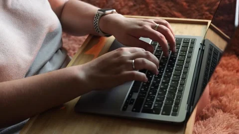 Close-up of hands typing on a laptop keyboard while wearing a smartwatch Stock Footage 340265314