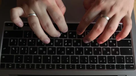 Close-up of hands typing on a laptop keyboard with Cyrillic letters Stock Footage 340265449