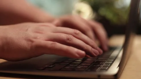 Close-up of hands typing on a laptop keyboard, focused on digital work Stock Footage 341737519