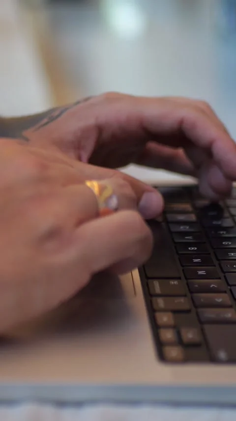 Close-Up of Hands Typing on Laptop Keyboard in Modern Workspace... Stock Footage 344455192
