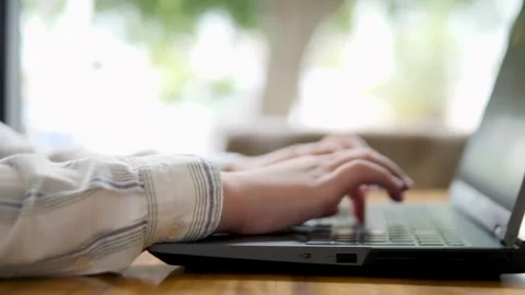 Close-up of Hands Typing on Laptop in Modern Workspace Stock Footage 316666941