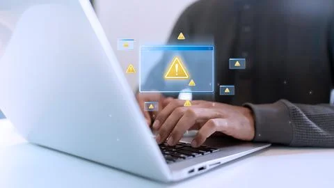 Close up of hands typing on a laptop with multiple virtual warning icons an.. Stock-Fotos