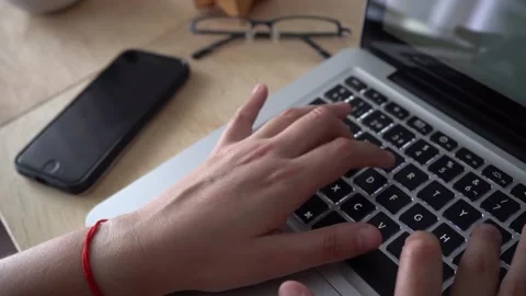 Close up of hands typing on a laptop at the office Stock Footage 171433198