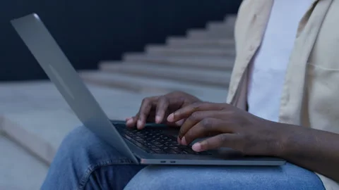 Close-up of hands typing on laptop outdoors Stock Footage 314389147