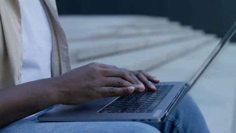 Close-up of hands typing on laptop outside Stock Footage 313744056