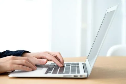 Close up of hands typing laptop. Selective focus on hands. Copy space. Stock Photos