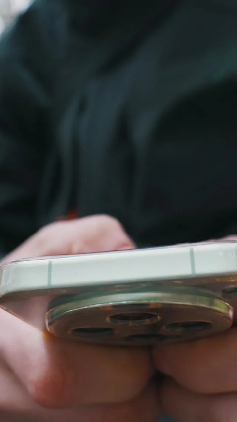 Close Up of Hands Typing on a Modern Smartphone in an Outdoor Setting Video stock 333824559