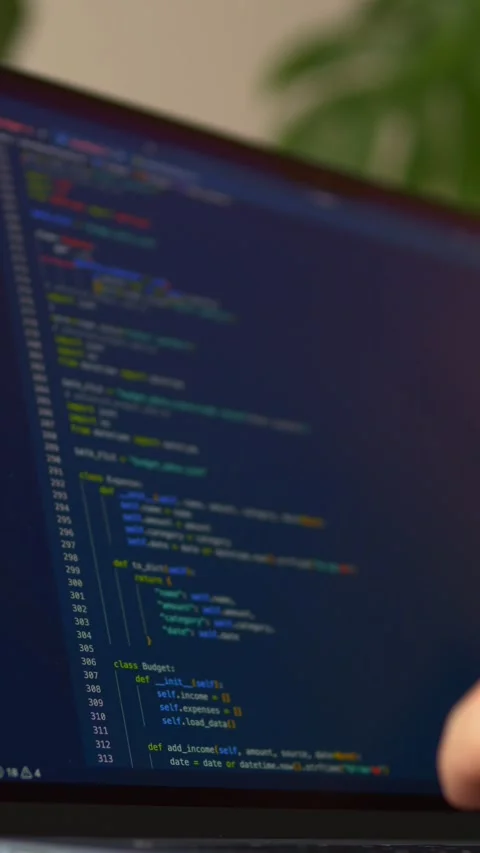 Close-up of hands typing programming code on laptop keyboard while AI assistant Stock Footage 345652886