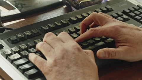 Close Up of Hands Typing Slowly on Computer Keyboard in Focused Work Session Stock Footage 337765046