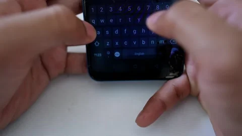Close-up of hands typing on a smartphone with a cracked screen Stock Footage 317736829