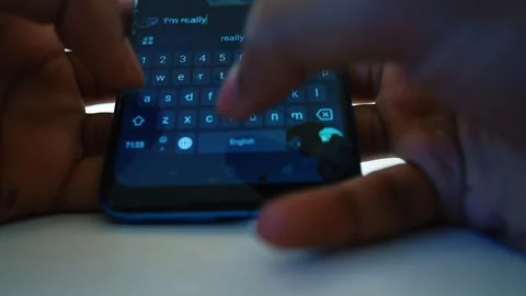 Close-up of hands typing on a smartphone with a cracked screen Stock Footage 320724513