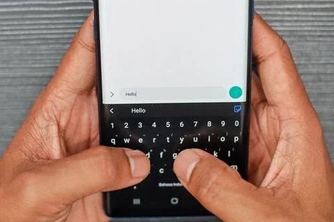 Close Up Of Hands Typing On A Smartphone Keyboard With Blurred Background Stock Photos